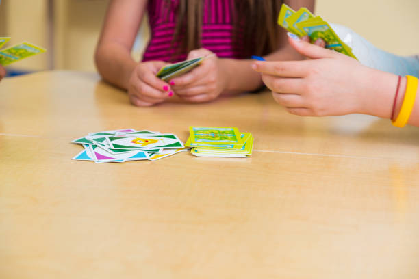 istock School children playing card game 1428987966