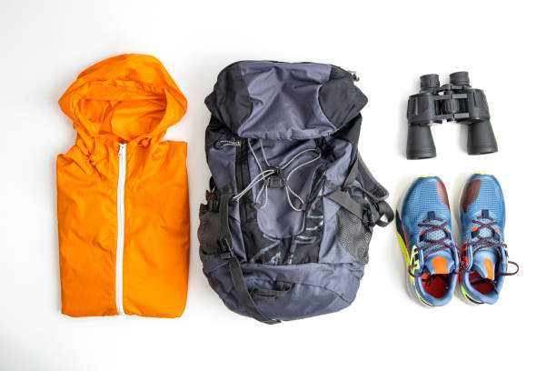 istock Raincoat, backpack, sneakers, binoculars on a white background. Top view, flat lay 1428988007