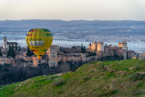 Granada, Spain, 29 January 2022. A hot air balloon rises to fly over Granada's Alhambra