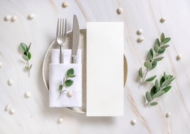 istock Elegant Table setting with a card decorated with eucalyptus branches top view, Wedding mockup 1428992000