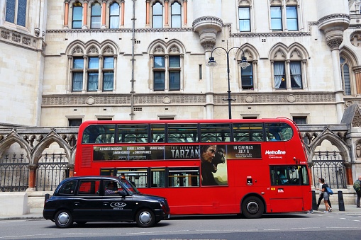 People ride a double decker bus at The Strand, London, UK. Transport for London (TFL) operates 8,000 buses on 673 routes.