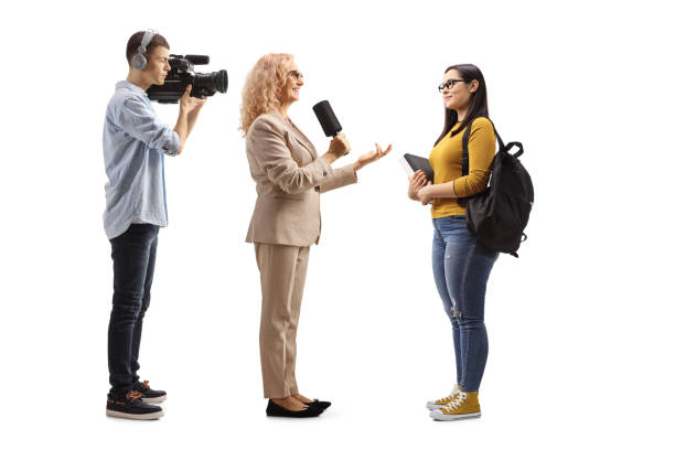 istock Female reporter interviewing a student and camera man recoridng 1428995553
