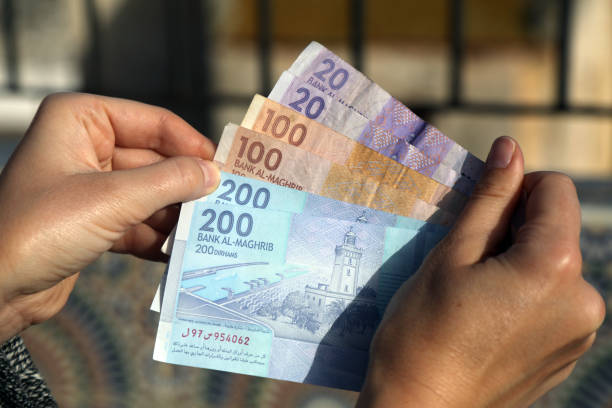 Moroccan dirhams money Moroccan dirhams. Currency of Morrocco - hand holding used banknotes. Moroccan money. moroccan currency photos stock pictures, royalty-free photos & images