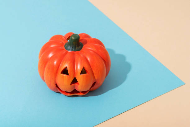 Jack-O-Lantern on blue and beige background. Halloween concept.