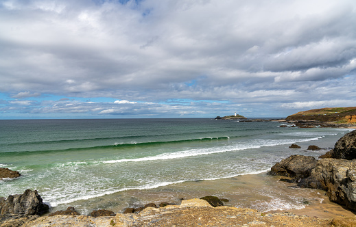 view of St. Ives Bay and small beach near Gwithian with the Godrevy Lighthouse in the background