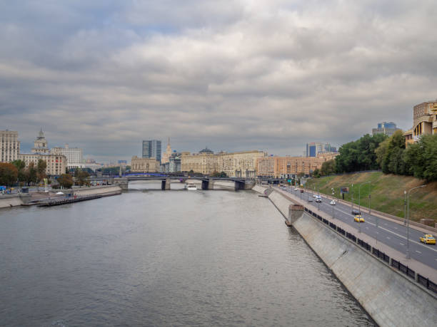 Moscow. Russia. September 22, 2022. View from the Bogdan Khmelnitsky pedestrian bridge to the Moskva River, Rostovskaya embankment and the government house of the city of Moscow on a cloudy autumn day