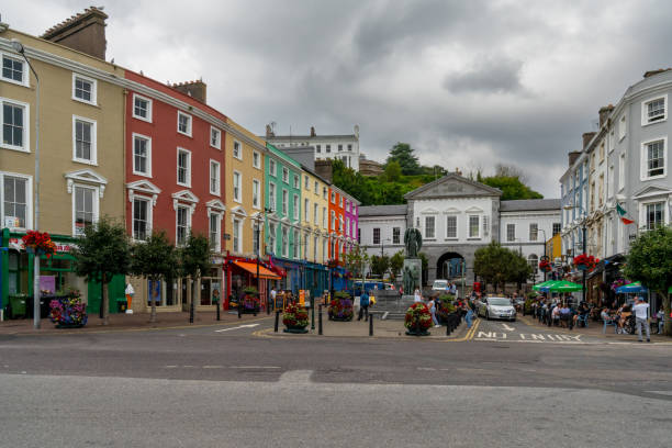 town square in Cobh with colorful houses and the Lusitania Memorial statue Cobh, Ireland - 15 August, 2022: town square in Cobh with colorful houses and the Lusitania Memorial statue 1910 1919 photos stock pictures, royalty-free photos & images