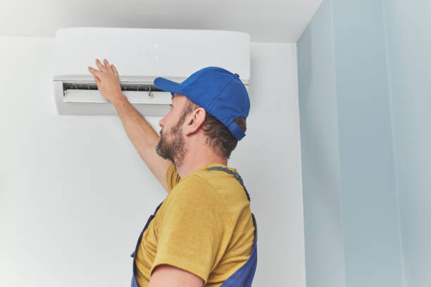 istock Repairman cleaning and fixing indoors AC unit. 1429006860