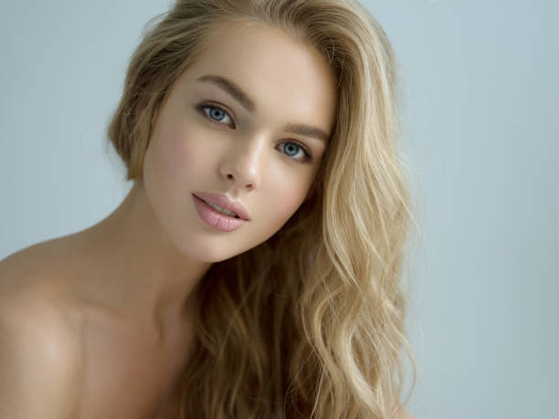 istock Young blond woman with long curly hair. 1429007563