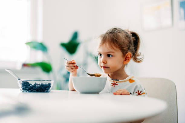 istock Happy Little Girl Having Cereals For Breakfast At Home 1429007778