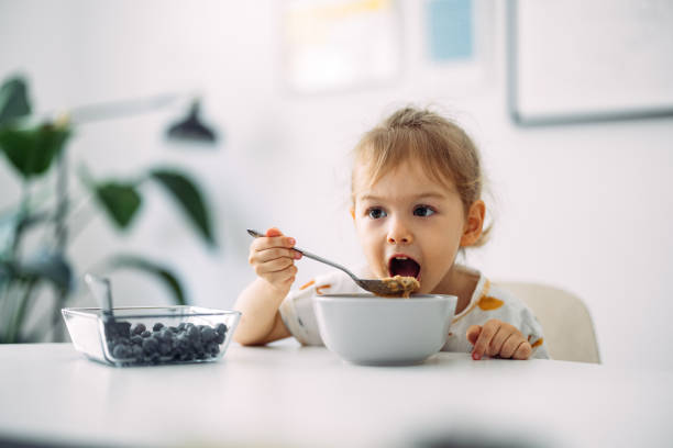 istock Happy Little Girl Having Cereals For Breakfast At Home 1429007785