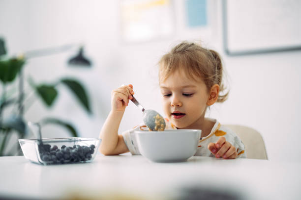 istock Cute Little Girl Having Cereals For Breakfast At Home 1429007794