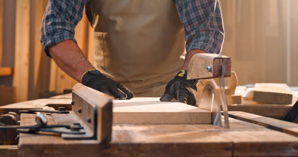 istock Male carpenter cutting wooden plank 1429008649