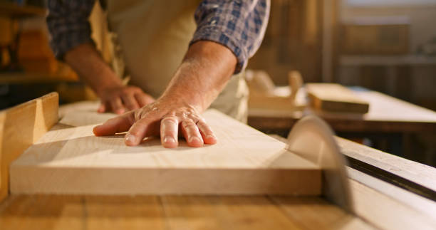 istock Male carpenter cutting wooden plank 1429008981