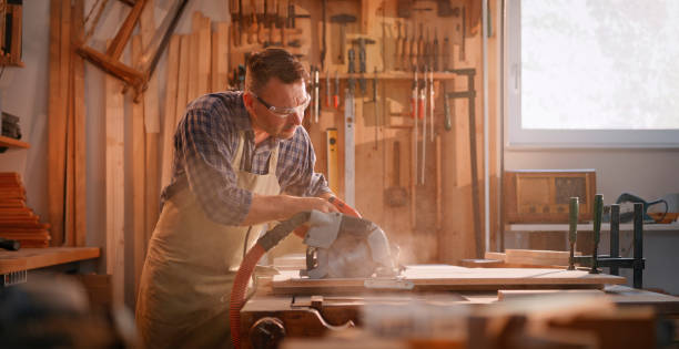 istock Male carpenter cutting wooden plank 1429009014