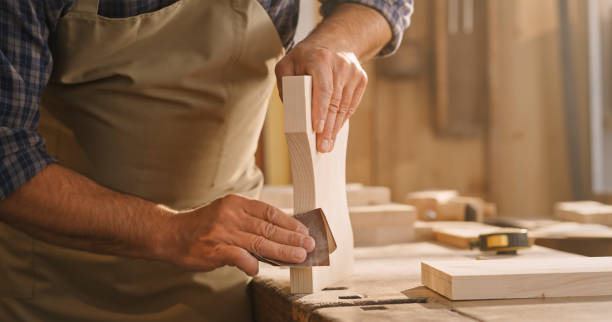 istock Male carpenter sanding wooden plank 1429009031