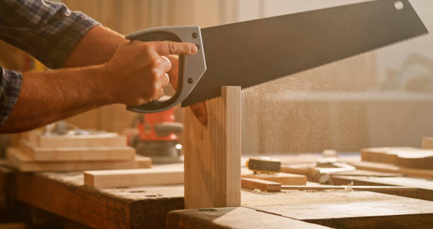 istock Male carpenter cutting wooden plank 1429009054