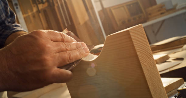 istock Carpenter's hand sanding wooden plank 1429009182