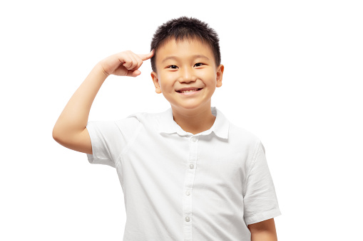 Happy kid with finger pointing head with smile isolated on white background