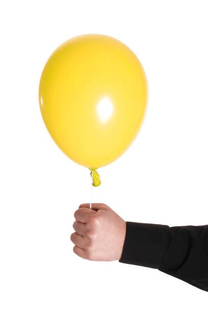 istock man holding yellow baloonn 1429023633