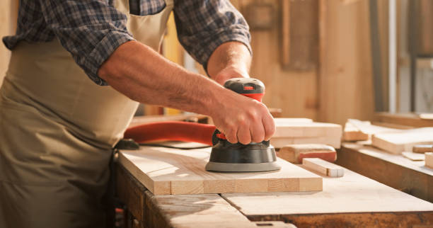 istock Male carpenter sanding wooden plank 1429027655