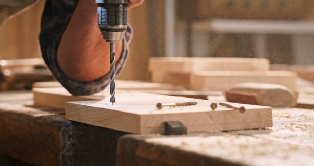 istock Male carpenter drilling wooden plank 1429027709