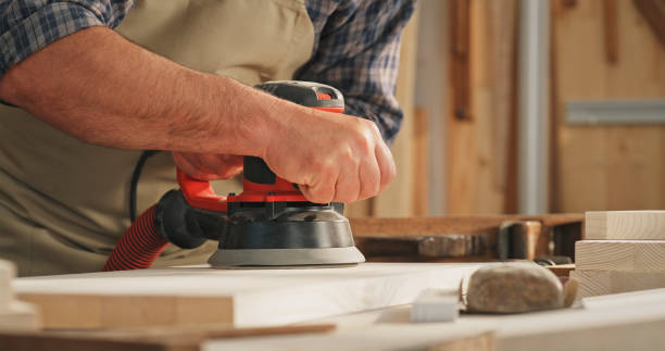 istock Male carpenter sanding wooden plank 1429027786