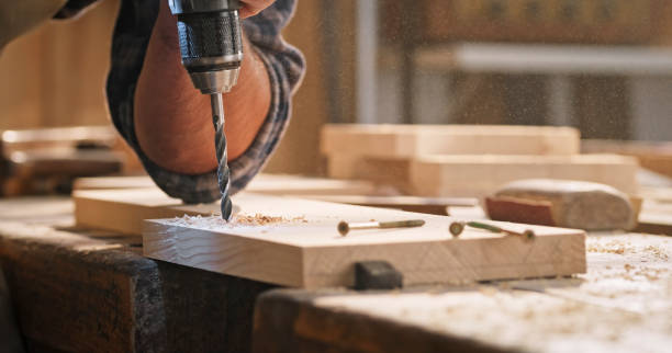 istock Male carpenter drilling wooden plank 1429027796
