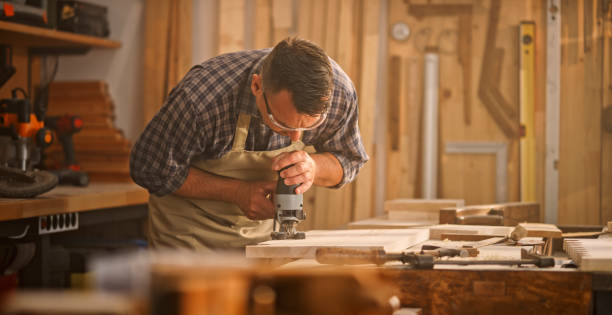 istock Male carpenter cutting wooden plank 1429028083