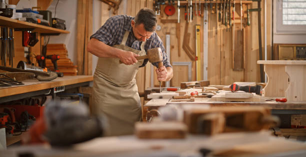istock Carpenter carving wood with chisel 1429028674