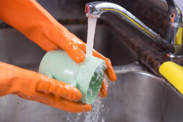 istock hands with gloves washing a cup 1429028745