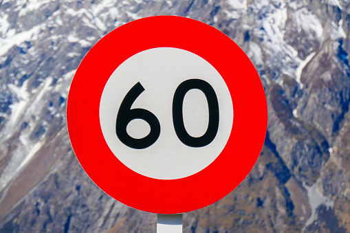 Sixty km/h speed limit road sign on Tasman Valley Road in Aoraki Mount Cook National Park.  This image was taken on an afternoon in early Spring.