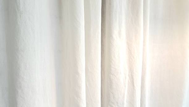 istock The window is covered with a white tulle curtain, white tulle curtain  texture. 1429033305