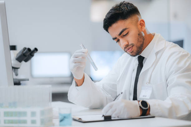 istock Lab, test tube and scientist man writing research documents report on sample, analysis and testing info. Medical male researcher, laboratory worker and chemist chemical drug experiment data results. 1429038682
