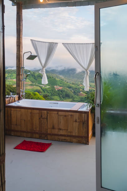 Vertical photo of an accommodation in Chiang Mai There is an open-air bath, looks luxurious. Cloudy mountain backdrop, travel, stock photo