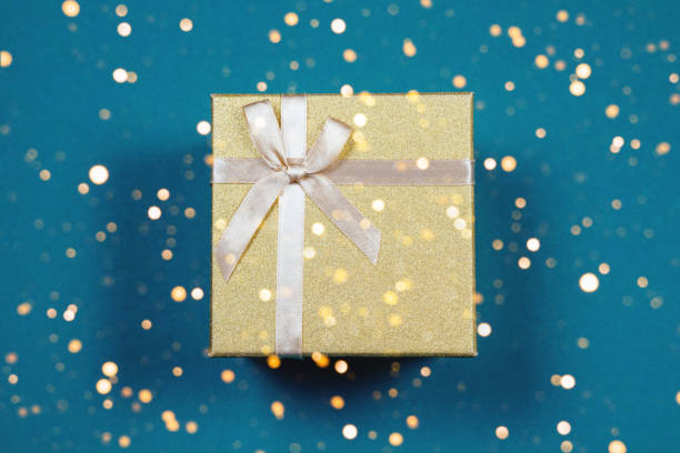 istock Golden gift box on a blue background. 1429048104