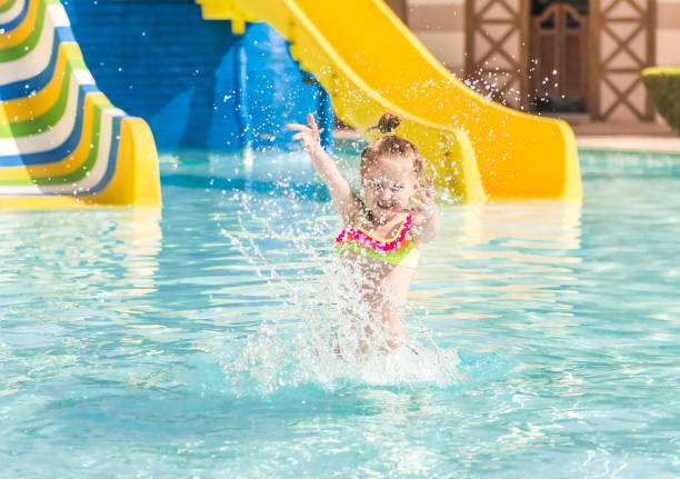 istock Smiling girl swim to the poolside 1429054495