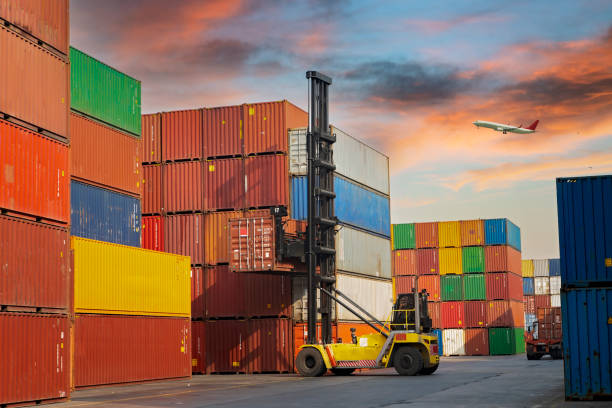 istock Airplane flying above container port. 1429055009