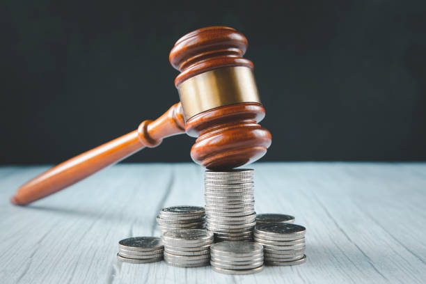 istock Old wood Judge hammer with stacking coins in close-up and coins stack the table wood background, Used for adjudication and Justice. 1429058957