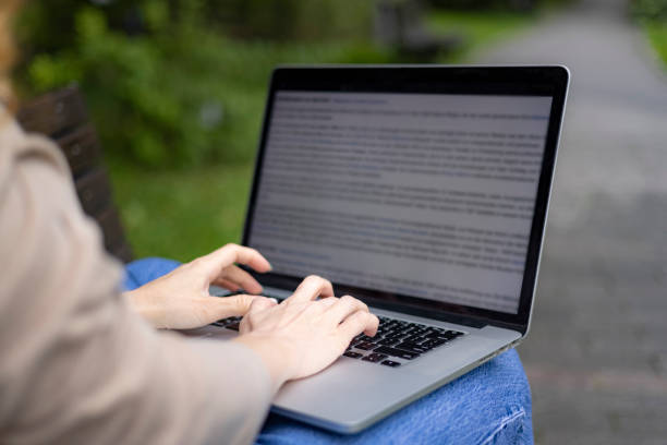 istock Typing on a laptop while sitting outdoors 1429058979