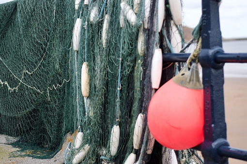 Fishing boat net drying on cobble landing at Filey East Yorkshire coast.