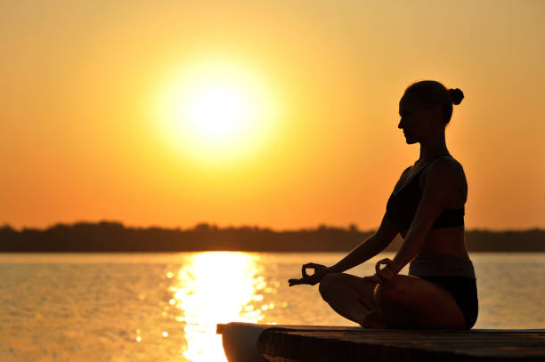 istock Woman relaxing at the sunset background low key picture 1429062194