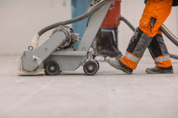 istock Workers grind the concrete floor at the construction site. 1429062346