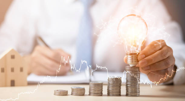 istock Businessman hand holding light bulb with line connect and Coins stack on the wooden table, Saving ideas and investment budget, Creative ideas concept of saving money  concept, Copy space 1429062849