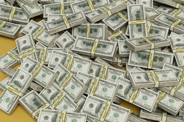 istock stacks of paper dollars on a yellow background. 3d render 1429063357