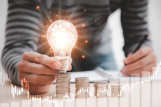 istock Business hand holding light bulb and working with computer on the desk, Creativity and innovation are keys to success.Concept of new idea and innovation with Brain and light bulbs 1429063394