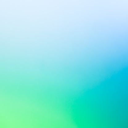 A completely defocused image with a natural color gradient from light green to dark blue.