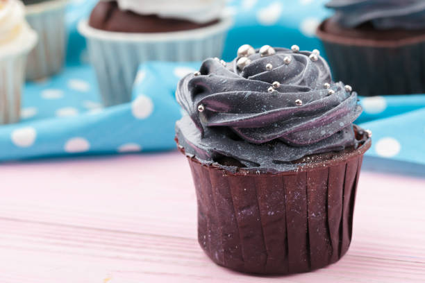 istock Cupcakes decorated with sprinkles and frosting - close up 1429064801