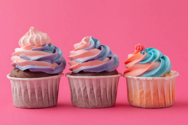 istock Tasty cupcakes sweets on pink background close up 1429064809