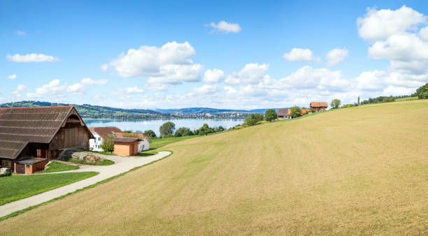 Beautiful touristic summer scenery in Central Switzerland. Lake Sempach with farms and far off rural villages. Sempacher See, Luzern. Selective focus.